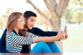 Cute Couple Using PC Tablet Outdoors in Nature