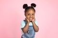Funny happy smiling little cute African-american girl, with afro hair in two ponytails, posing with her arms under face Royalty Free Stock Photo
