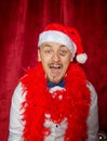 Funny happy smiling toothless man wearing Santa hat big fat bruise under his eye. New Year style Royalty Free Stock Photo