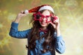 Funny happy teenage girl in Santa hat and Royalty Free Stock Photo