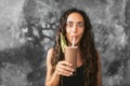 Funny happy woman drinking chocolate milk shake with cocoa and laughing Royalty Free Stock Photo