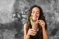 Funny happy woman drinking chocolate milk shake with cocoa and laughing Royalty Free Stock Photo