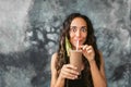 Funny happy woman drinking chocolate milk shake with cocoa and laughing Royalty Free Stock Photo