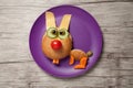 Funny hare made of bread, cheese and vegetables on plate and table Royalty Free Stock Photo