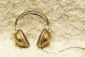 Funny headphones with golden On shaggy bedspread