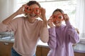 Funny healthy vegan family make pepper glasses looking at camera