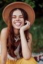 Funny hippie girl shows her tongue to the camera close-up, a lifestyle of travel and harmony with nature