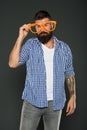 Funny hipster in extravagant glasses. Fashion man with beard. Playful guy enjoying party. Funny glasses accessory
