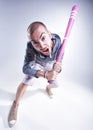 Funny hooligan with a pink baseball bat screaming in the studio Royalty Free Stock Photo