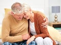 Funny, hug or happy senior couple with love, care or joy together on sofa at home in retirement. Relax, silly joke or Royalty Free Stock Photo