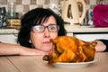 Funny hungry woman looking on chicken
