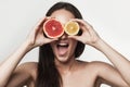 Funny image of young woman holding grapefruit and lemon Royalty Free Stock Photo
