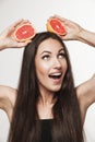 Funny image of young woman holding grapefruit Royalty Free Stock Photo