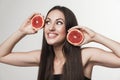 Funny image of young woman holding grapefruit Royalty Free Stock Photo