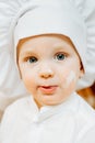 Funny inquisitive caucasian grimy boy in white cap