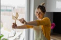 Funny, inspired, smiling blonde woman joying cooking, crossing wooden kitchen spatula stiff armed. Cook training course