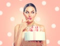 Funny joyful beauty model girl holding big beautiful party or birthday cake over pink background