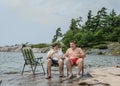 Funny joyful friends talking laughing relaxing in park near the lake Royalty Free Stock Photo