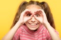 Funny joyful playful girl look hand binoculars