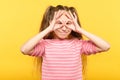 Funny joyful playful girl look hand binoculars