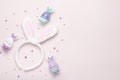 Funny kawaii cute bunny eggs and bunny rabbit ears for kids in pastel colors on pink table top, Easter holiday concept. Easter