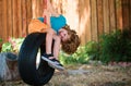 Funny kid boy having fun with chain swing on outdoor playground. Child playing on the playground in kindergarten. Joyful Royalty Free Stock Photo