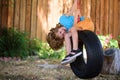 Funny kid boy having fun with chain swing on outdoor playground. Child playing on the playground in kindergarten. Joyful Royalty Free Stock Photo