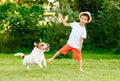 Funny kid boy throws stick to his dog playing fetch game Royalty Free Stock Photo