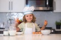 Funny kid with eggs at kitchen. Chef kid cook baking at home kitchen. Kid chef cook cookery at kitchen. Cooking