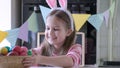 Funny kid girl with bunny ears play Easter hare hunter at home Royalty Free Stock Photo