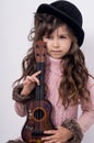 Funny kid girl with guitar, ukulele guitar.