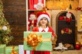 Funny kid holding Christmas gift. The morning before New Year. Christmas kids - happiness concept. Christmas kids.