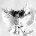 Funny kid making snow angel. Child girl playing and making a snow angel in the snow. Top view. Royalty Free Stock Photo