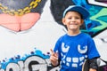 Funny kid pointing up in front of a graffiti wall Royalty Free Stock Photo
