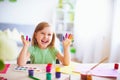 Funny kid show their palms the painted paint. creative classes fine arts. child girl laugh. happy kid in drawing school Royalty Free Stock Photo