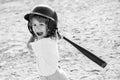 Funny kid up to bat at a baseball game. Close up child portrait.