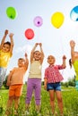 Funny kids with balloons in the air