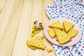 Funny kids cookies. Festive cheese crackers, New Year snack concept. Food, mouse sculpture, napkin. Wooden planks background