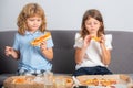 Funny kids eating pizza. Little girl and boy eat pizza. Royalty Free Stock Photo