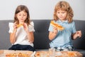 Funny kids eating pizza. Little girl and boy eat pizza. Royalty Free Stock Photo