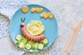 Funny kids lunch with mashed potatoes and sausage. Funny snail