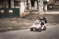 Funny kids playing with a rusty toy car in a poor street in Madagascar Royalty Free Stock Photo