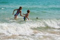 Funny kids playing in sea. The boys splashing in sea water. Family vacation in the tropics. Children play in ocean.