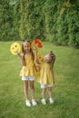 Funny kids show a variety of emoticons playing in the park