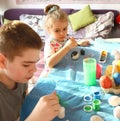 Funny kids with stained faces having fun at home in the kitchen. Brother and little sister. Funny. Creative concept. Mess at home Royalty Free Stock Photo