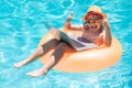 Funny kids summer face. Summer business. Child remote working on laptop in pool. Little business man working online on Royalty Free Stock Photo