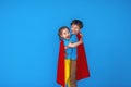 Funny kids is super strength hero in red cloak and mask. concept superhero