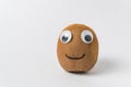 Funny kiwi fruit with Googly eyes and smile on white background. Kiwi character