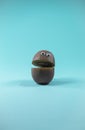 Funny kiwi with toy eyes and open mouth on trendy turquoise background