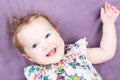Funny laughing baby girl in a colorful dress Royalty Free Stock Photo